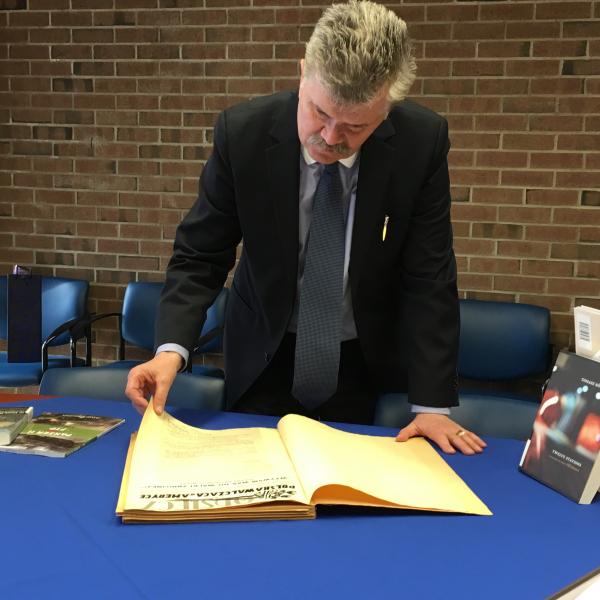 Dr. Kurnicki examines the Leddy Library's Polonia collection