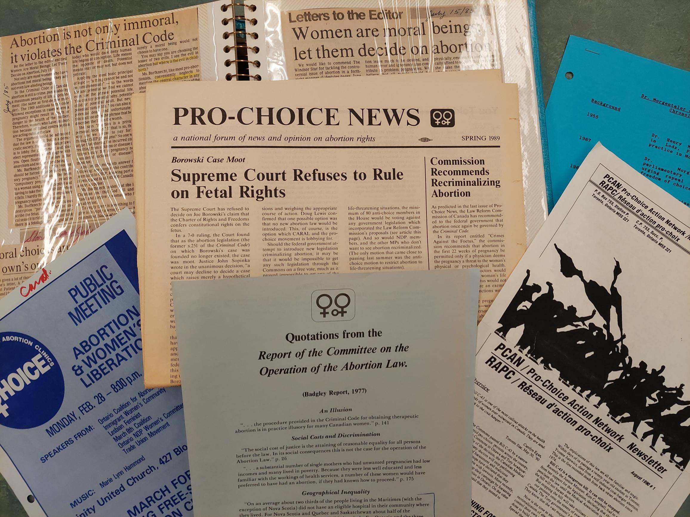 Archival documents and newspaper clippings displaying headlines that support either pro-choice or pro-life perspectives on abortion