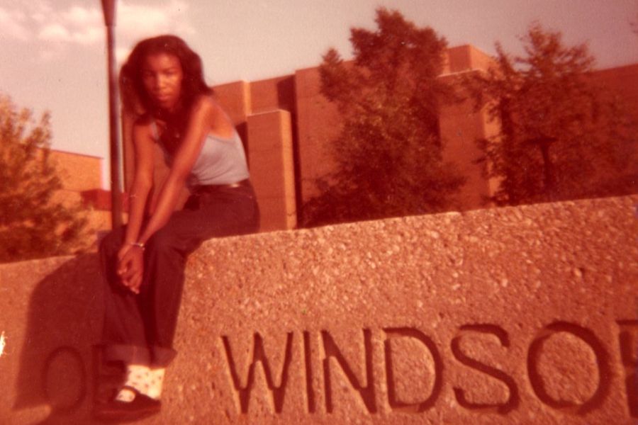 Young Antoinette sitting on University of Windsor wall in 1980.