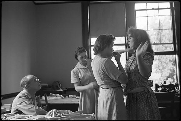Michael Chekhov looks on as Ludmila Chirikov and Lucy Singer fit Beatrice Straight for a costume in this photo by Nonny Gardner Cangelosi, used by permission.