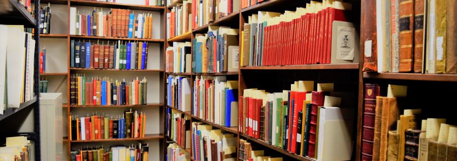 colourful old books on wooden bookshelves