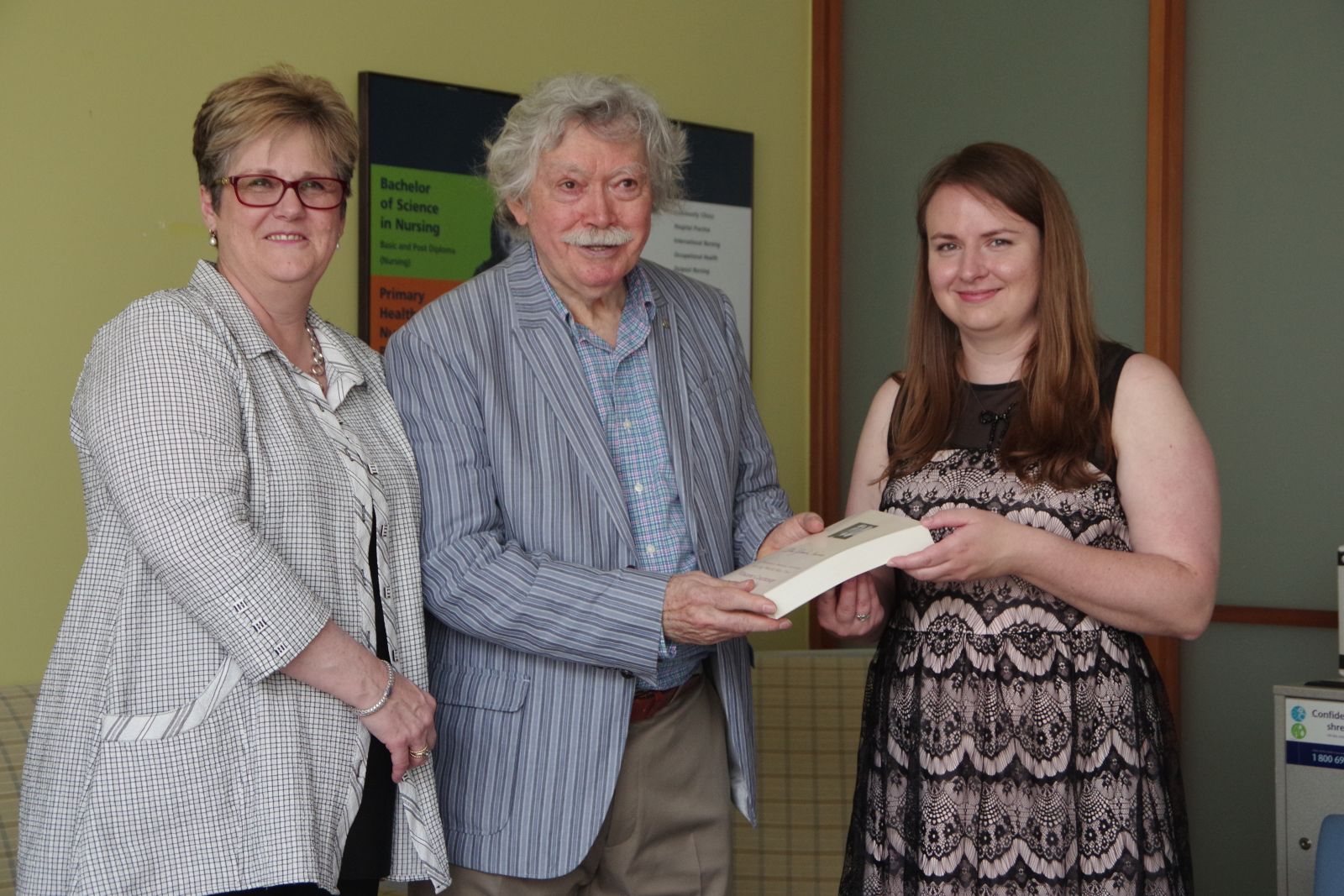 Image of author donating book to library