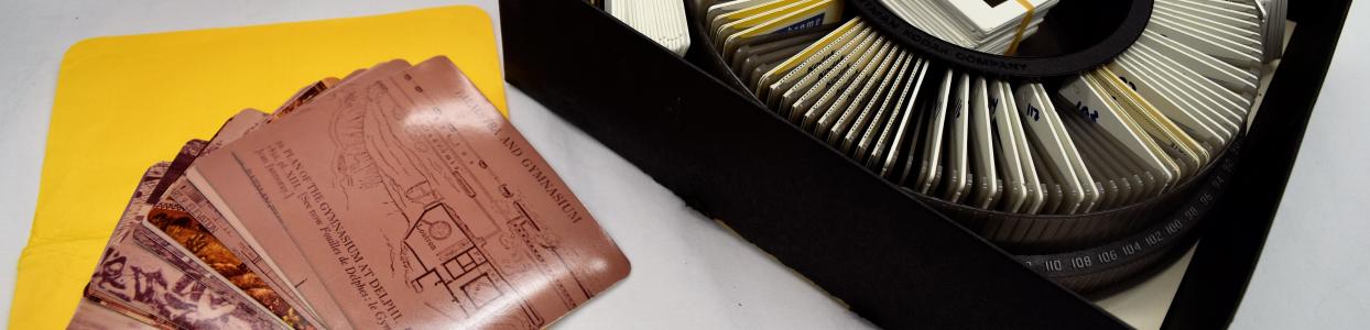 Print photographs and a carousel tray of photographic slides
