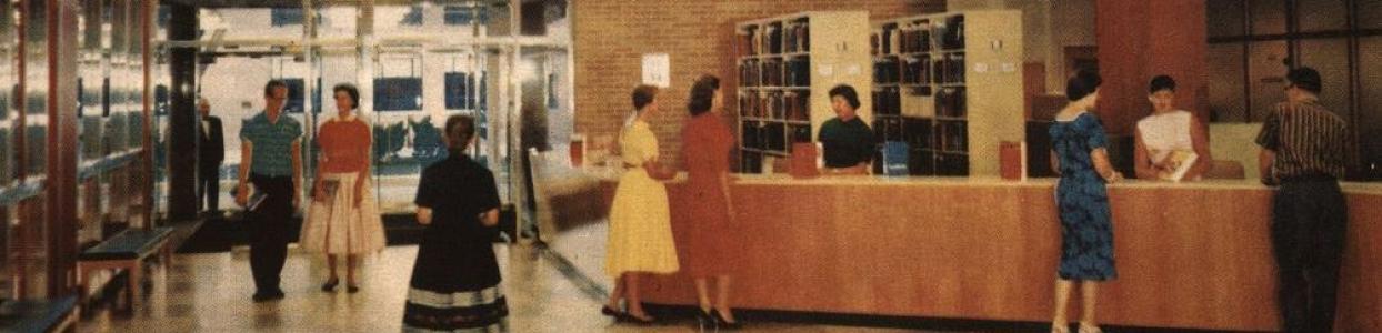 A photo of the old Assumption University Library, with multiple people interacting at the circulation desk.
