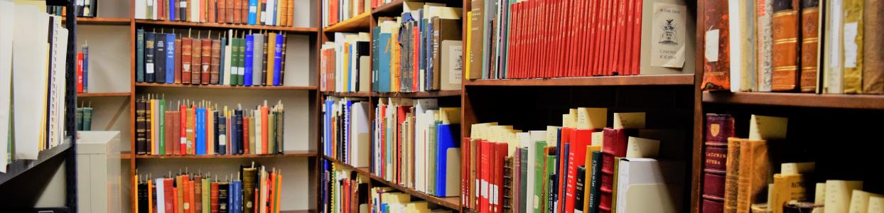 Corner shelving displaying rows of colourful books