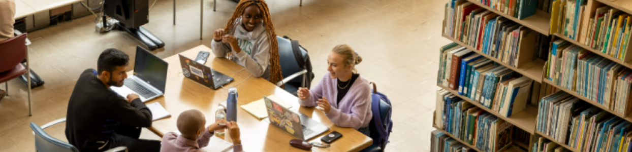 students sitting at a table talking together