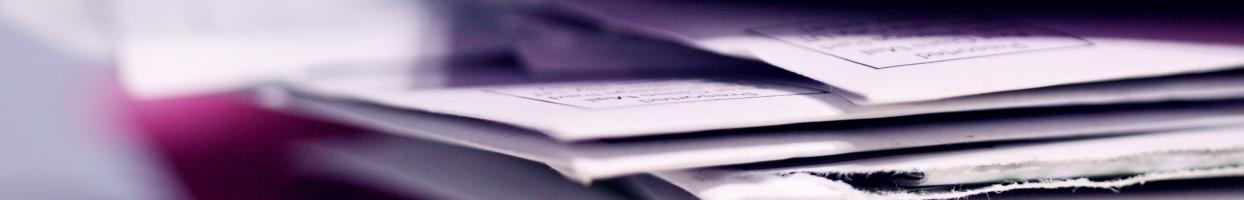 Photo of a stack of envelopes with only half the photo in focus. 