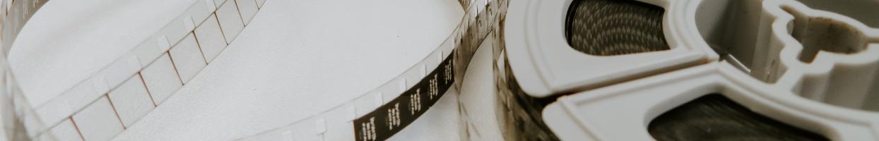Cropped photo of 8mm film and reel. 