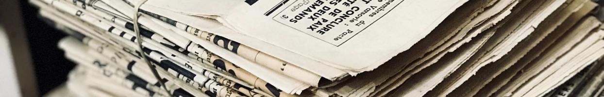 Photo of a bound stack of old newspapers.