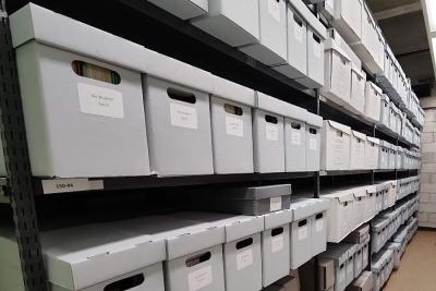 Image of gray boxes on shelves in the archives and special collections storage room.