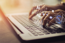 Hands typing on a lap top with AI overlay.