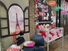 Mystery date with a book display showing wrapped books with Paris themed dinner table.