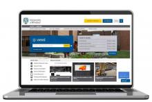 Computer with new library website displayed.