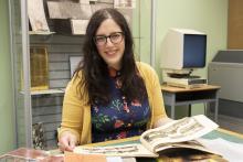 Alumna, Sarah Morris, working in the archives. 
