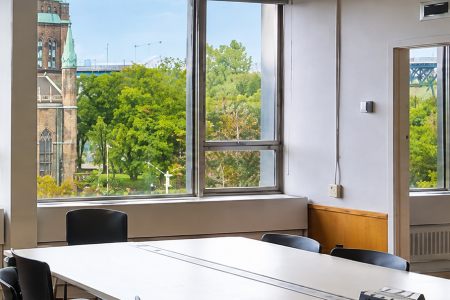 view of trees and boardroom table in the graduate defense room